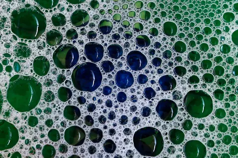 Soap bubbles clustered on a surface, seen close up
