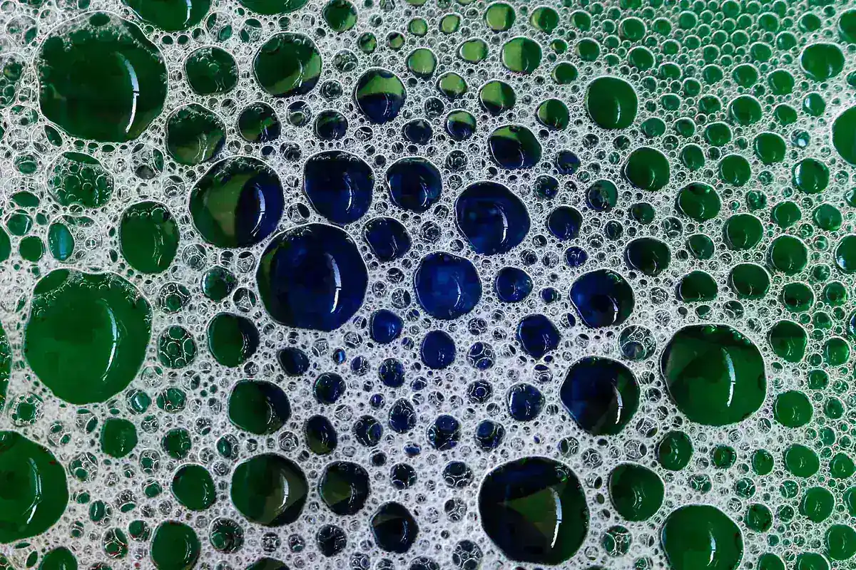 Soap bubbles clustered on a surface, seen close up