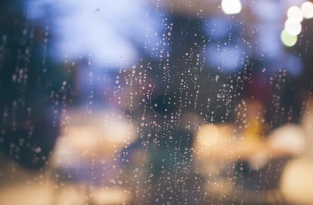 Water beading into tight domed droplets on coated glass, the signature behavior of a hydrophobic treatment