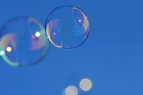 Soap foam and bubbles in close-up, the raw material of soap scum before it dries onto shower glass