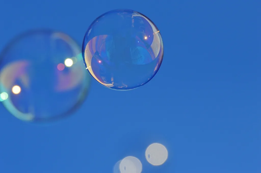 Soap foam and bubbles in close-up, the raw material of soap scum before it dries onto shower glass