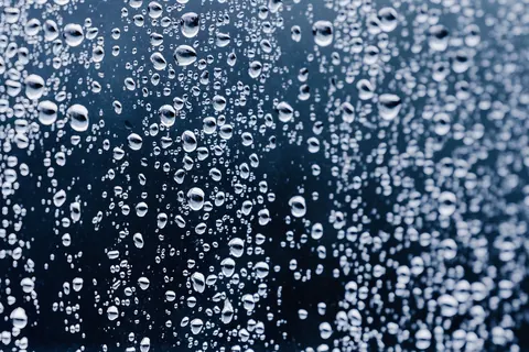 Water beaded into tight droplets across a pane of glass