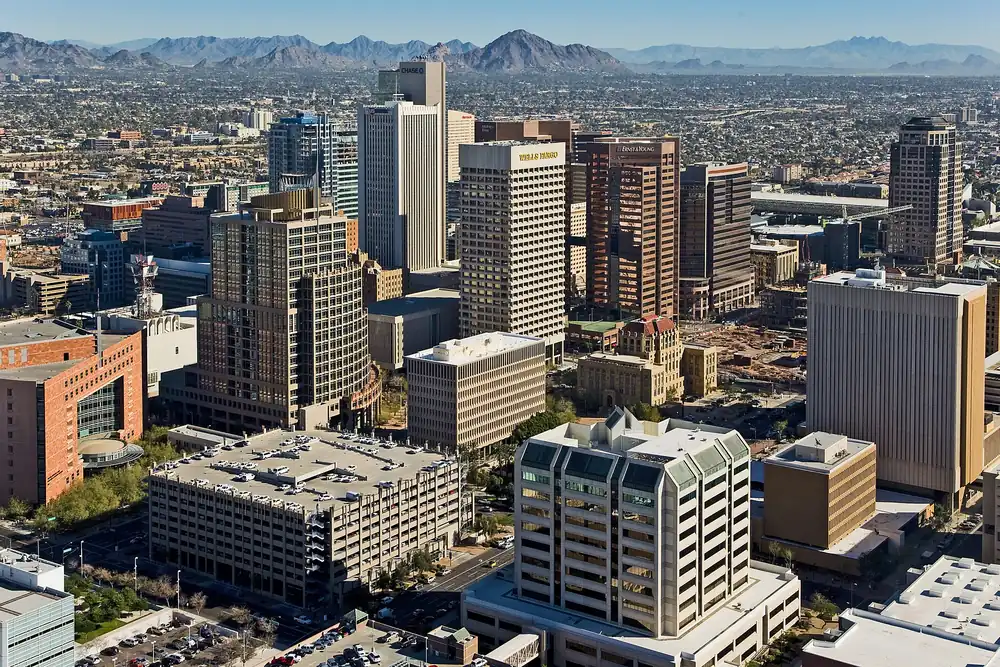 Downtown Phoenix office towers seen from the air, looking north-east toward the desert mountains