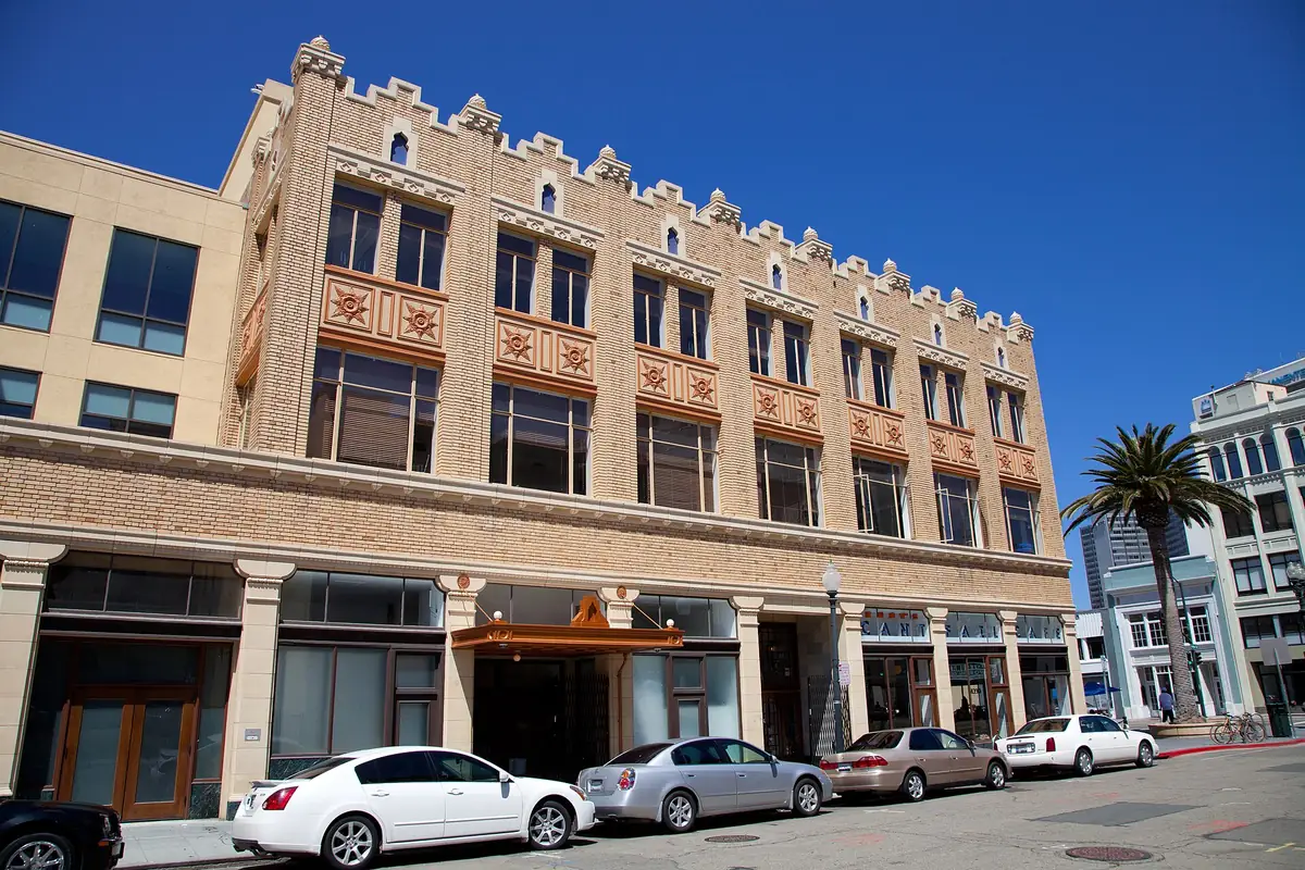 The ornate tan facade of the Fox Oakland Theatre building in downtown Oakland