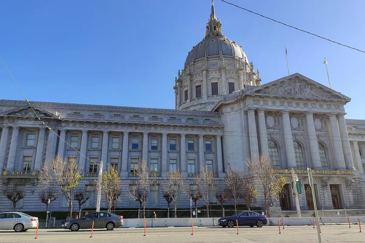 San Francisco City Hall's domed stone facade under a clear blue sky
