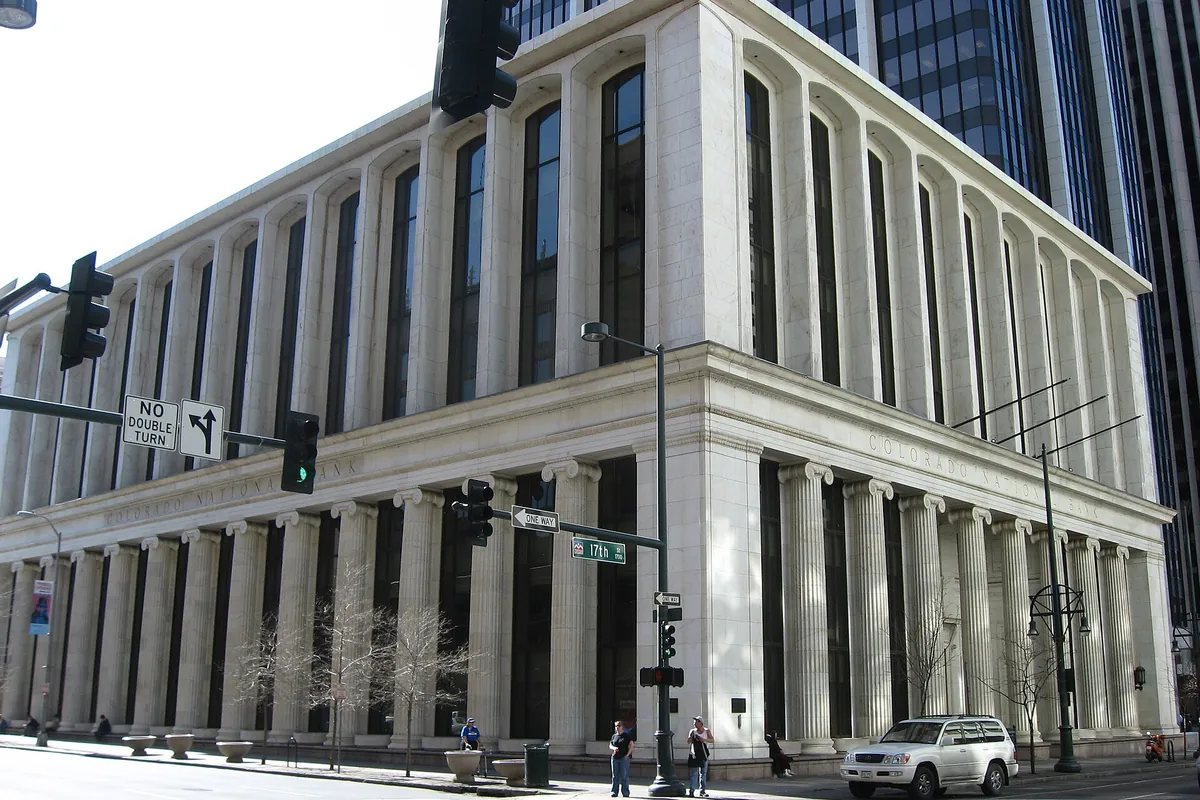 The columned Colorado National Bank building at 17th and Champa in downtown Denver, a glass tower behind it