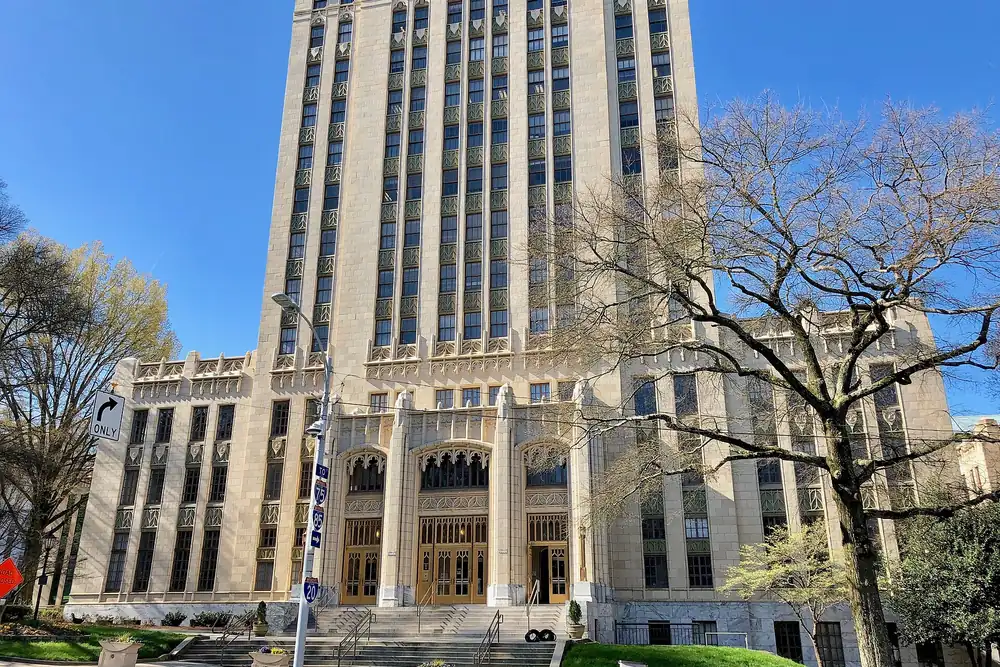 Atlanta City Hall's stepped Art Deco tower rising above bare spring trees