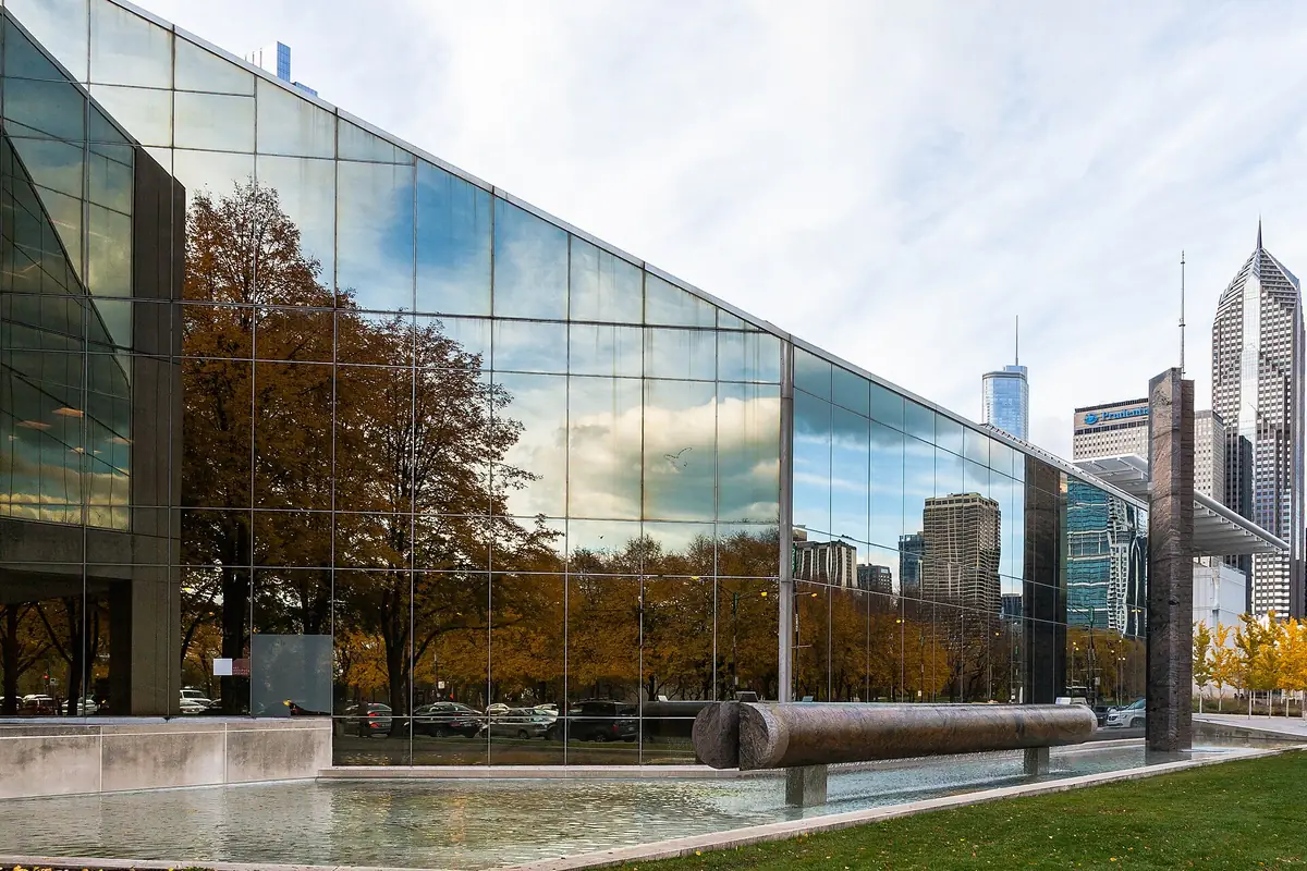 The glass curtain wall of the Art Institute of Chicago's Modern Wing, with Loop towers behind