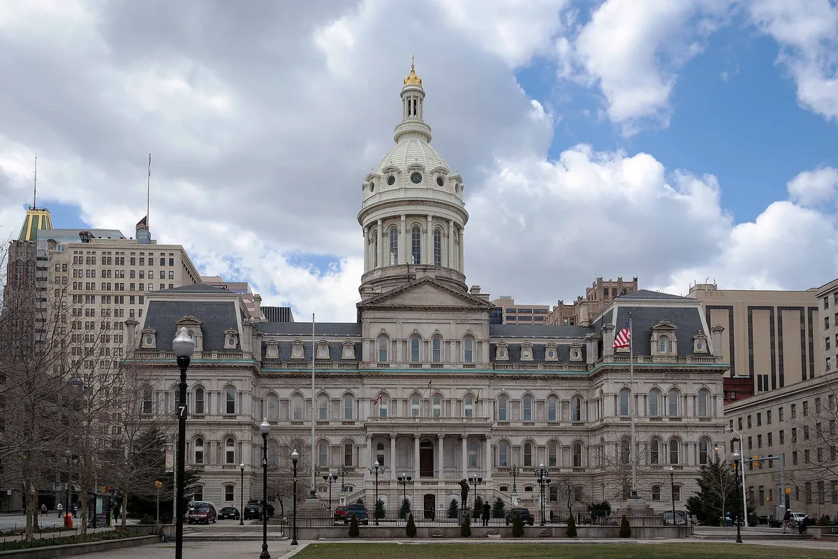 Baltimore City Hall's domed stone front seen from across the street