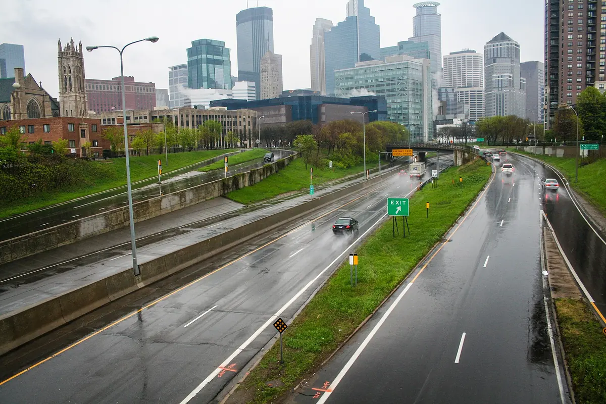Downtown Minneapolis glass towers beyond Interstate 35W on a wet autumn day