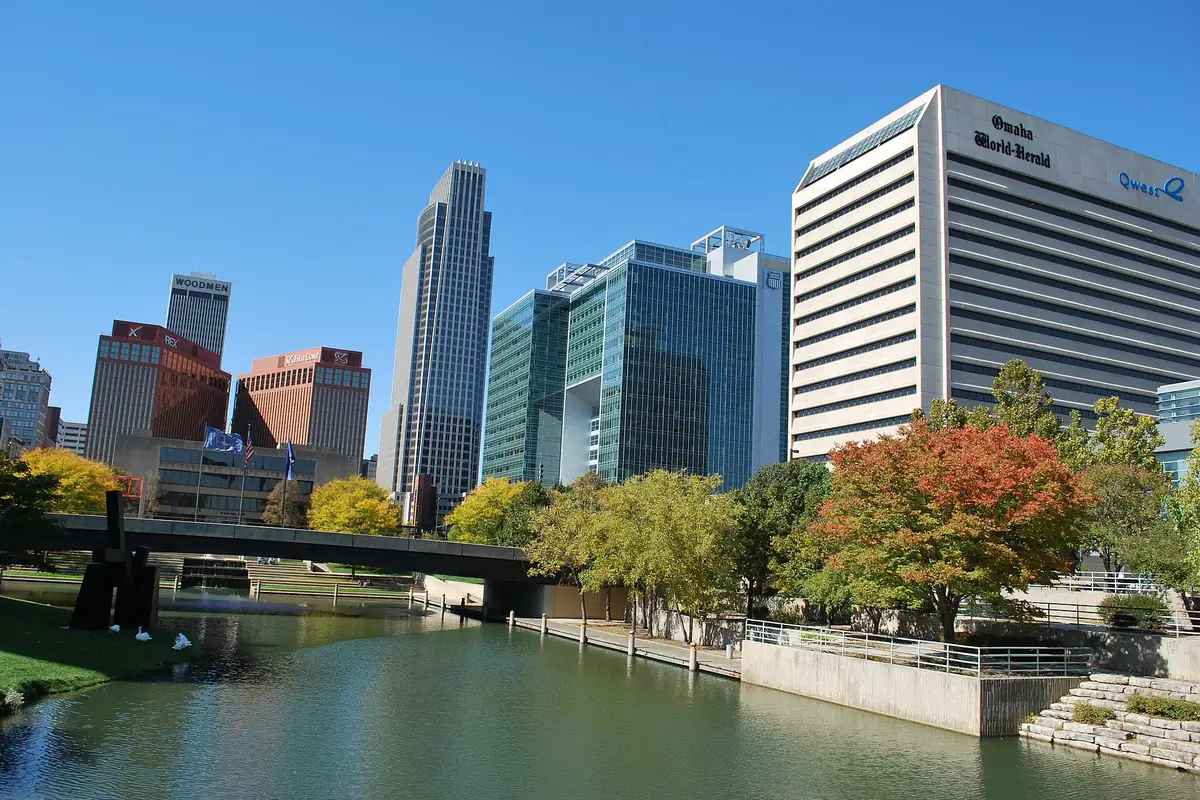 Downtown Omaha's office towers above a tree-lined lagoon on a clear autumn day