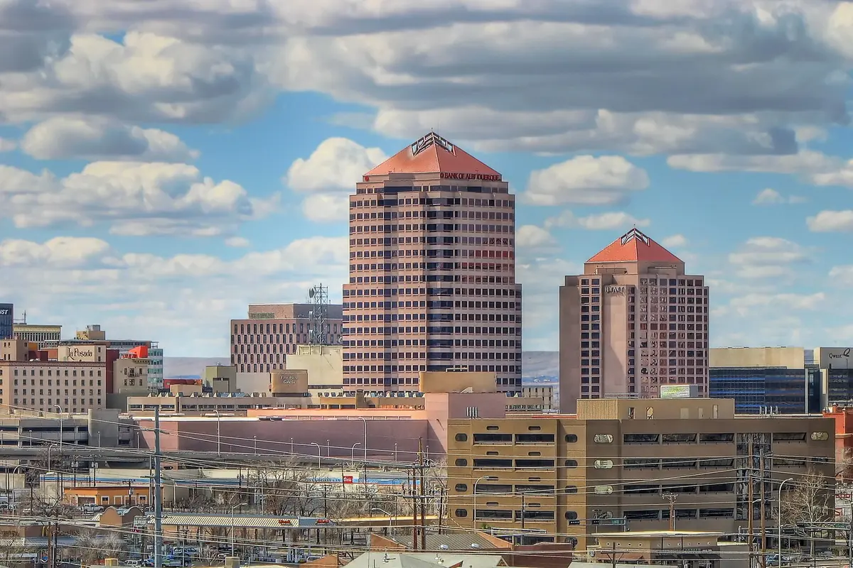Downtown Albuquerque's towers with their terracotta-coloured tops above low city blocks