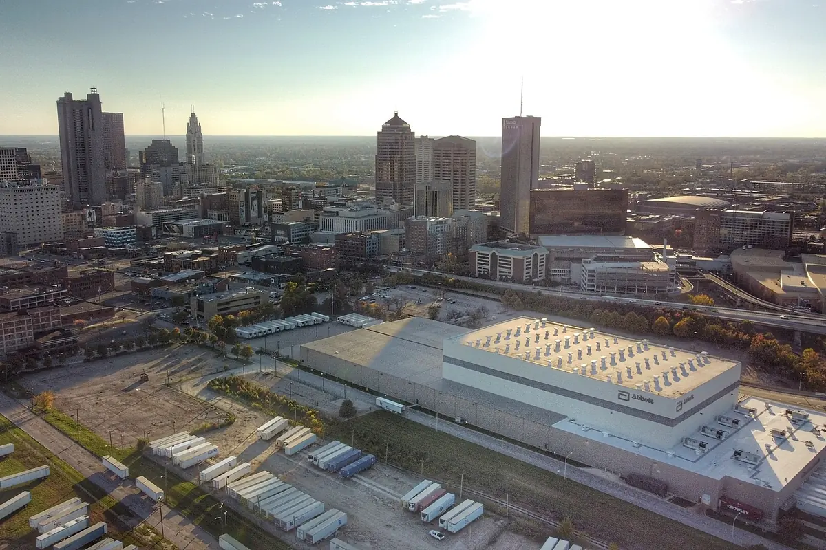 The downtown Columbus skyline from the air, with low industrial buildings in the foreground