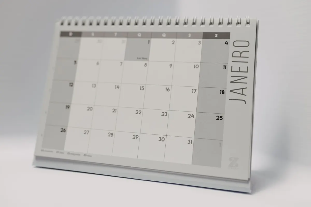 A desk calendar standing open at a month grid