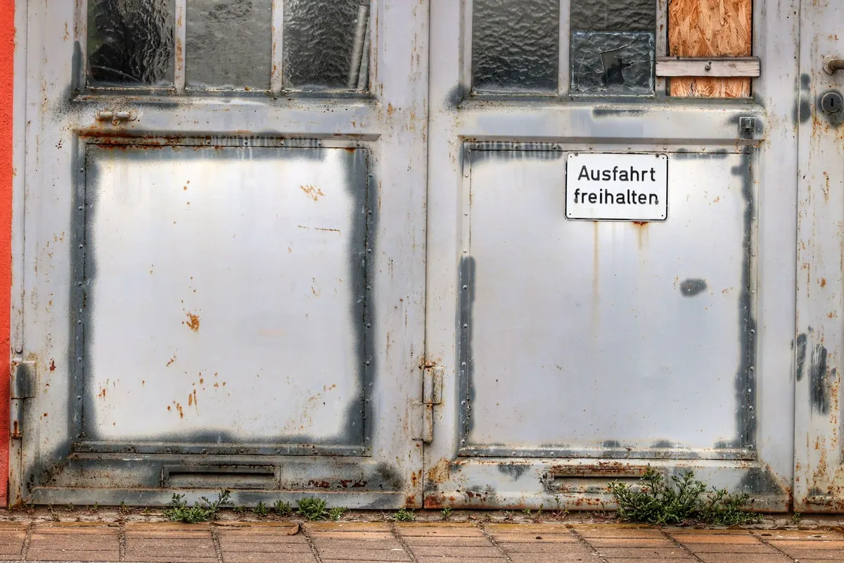 Weathered glass doors clouded with grime and white marks