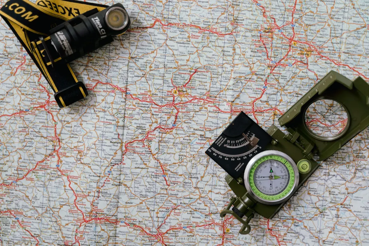 A road map with a compass laid on it