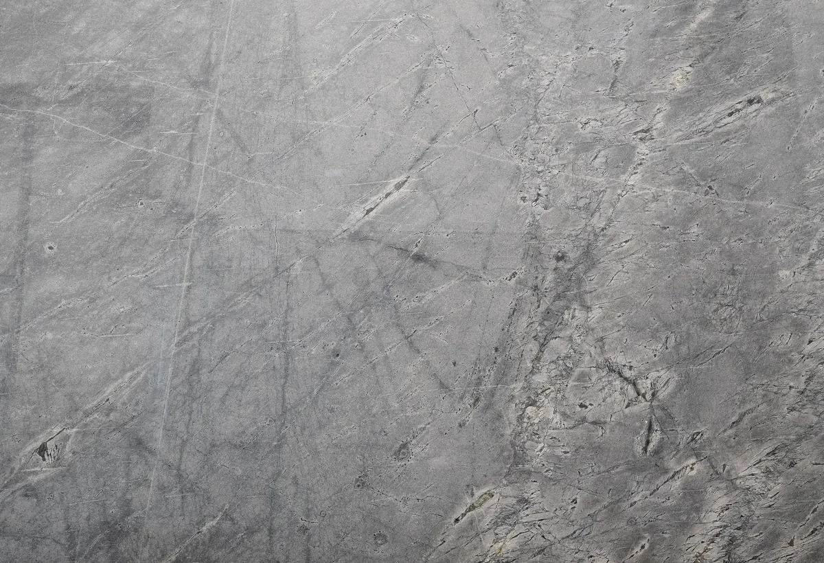A scratched grey surface seen close up