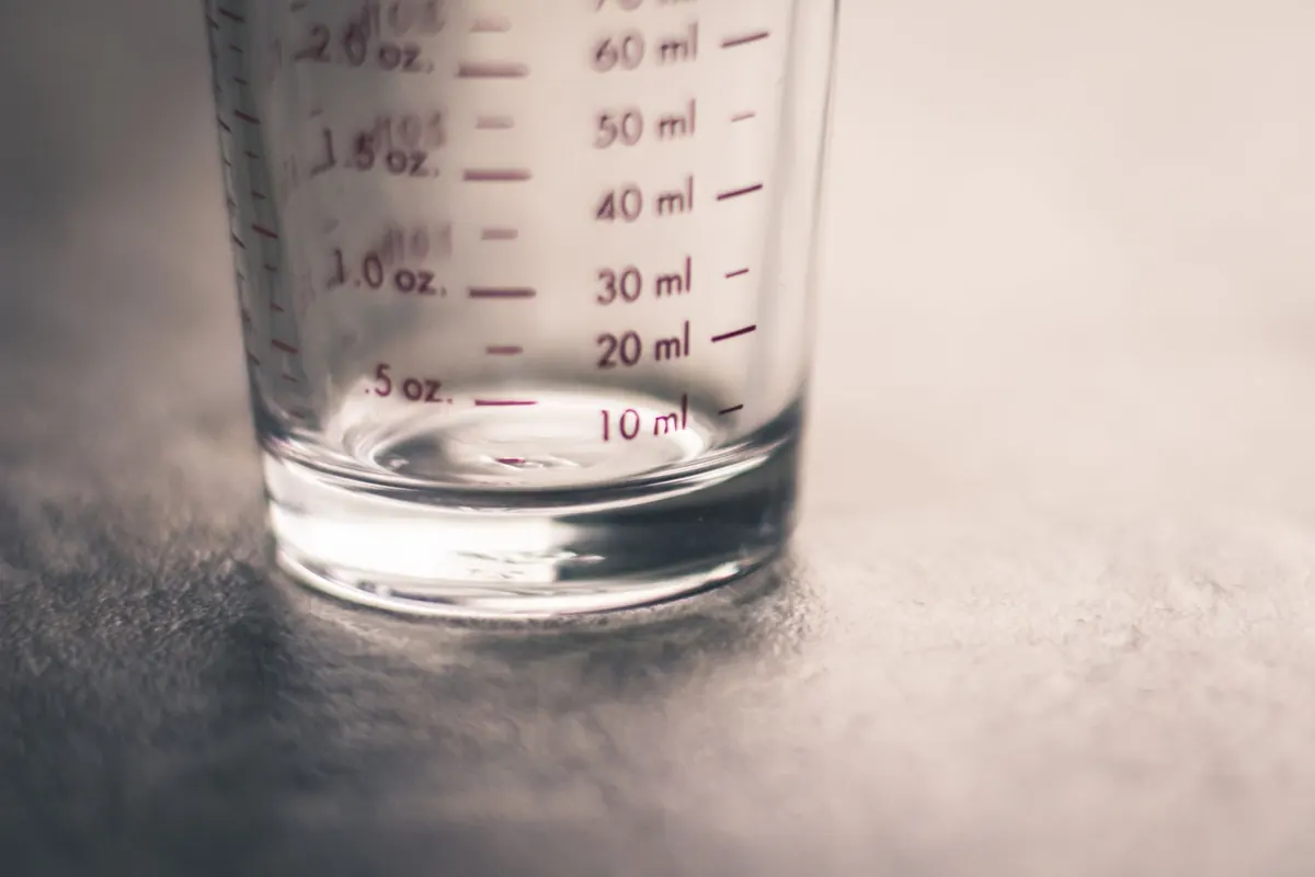 A graduated measuring glass standing on a table
