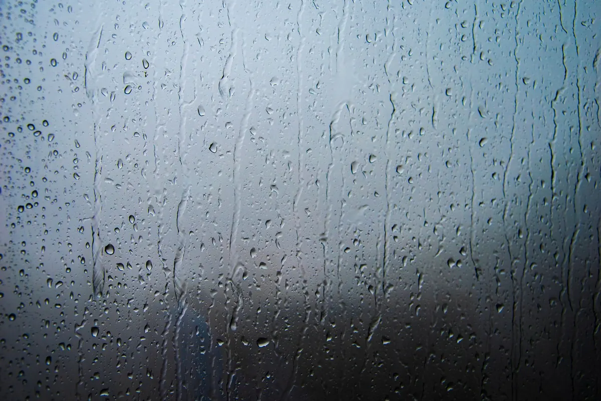 Water trails running down a pane of glass